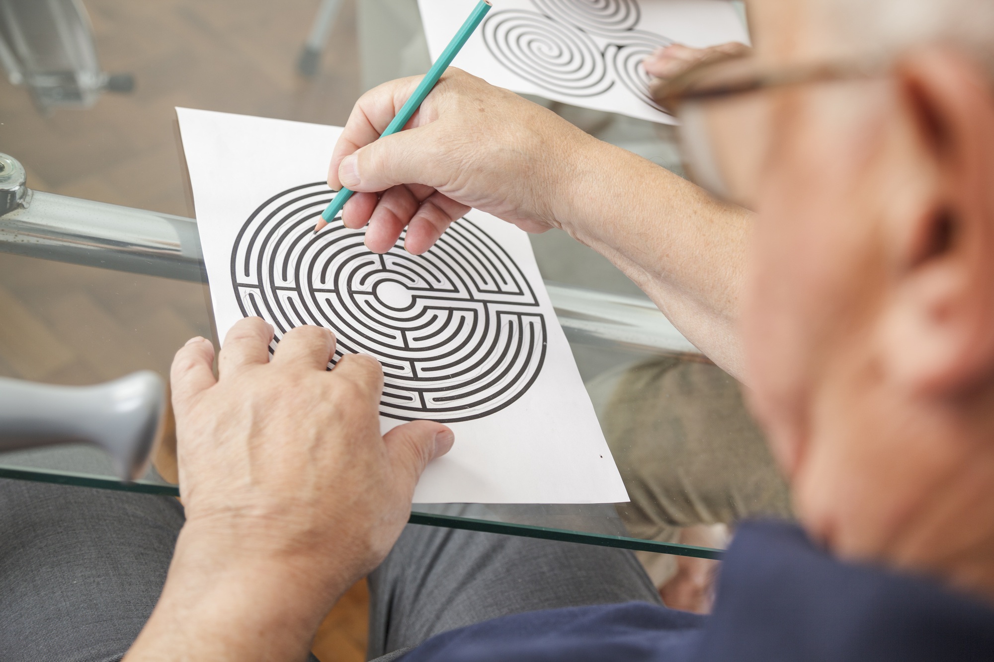 Senior Citizen Solving a Maze Puzzle